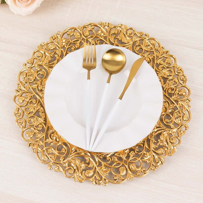 Elegant gold ornate charger plate with white plate and stylish cutlery on top.