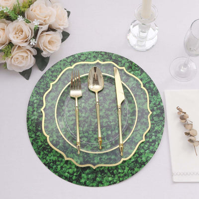 Elegant green and gold dinnerware set with floral centerpiece on a table.