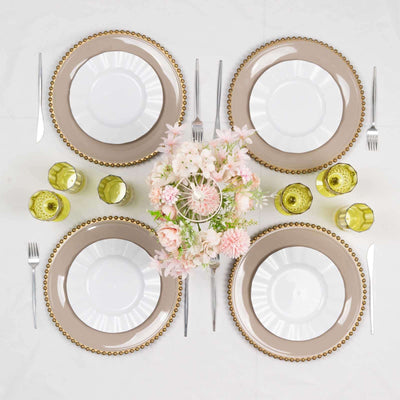 Elegant table setting with plates, glasses, and floral centerpiece.