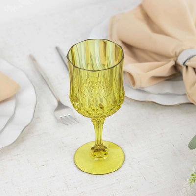 Yellow crystal goblet on a dining table setting.