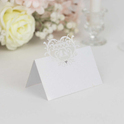 Elegant white place card with intricate cut-out design for events.