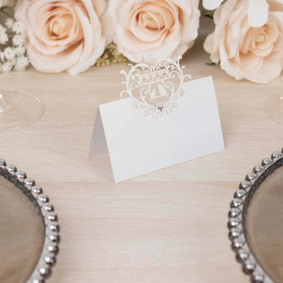 Elegant wedding place card with intricate design on a table setting.