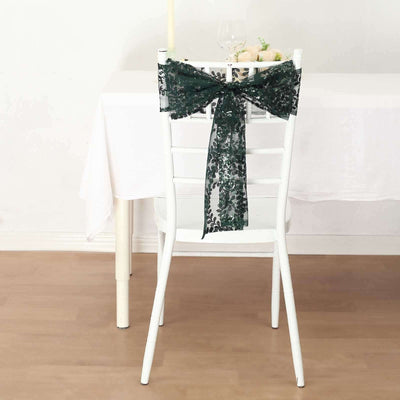 Green lace chair bow on a white chair at a dining table.