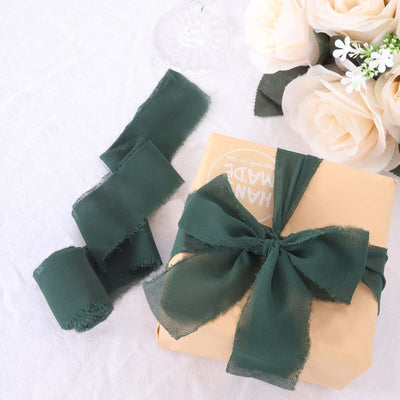 Gift wrapped in brown paper with a green ribbon and floral arrangement.