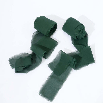 Green fabric ribbons arranged in a stylish cutout on a white backdrop.