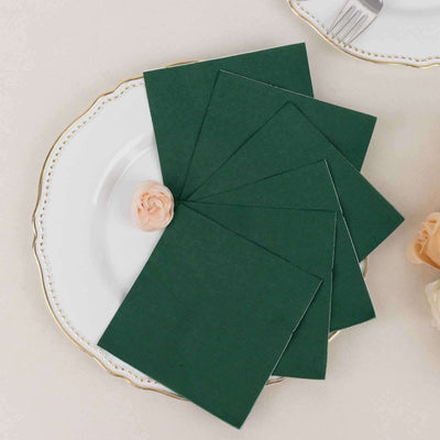 Green cardstock sheets arranged on a decorative plate with a flower accent.