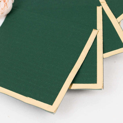 Green cardstock with gold edges stacked on a white background.