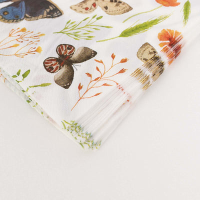 Colorful butterfly and floral patterned napkins stacked neatly.