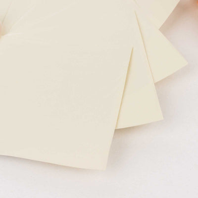 Cream-colored paper envelopes arranged neatly on a white surface.