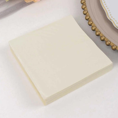 Beige sticky notes stack on a plain surface for office or home use.