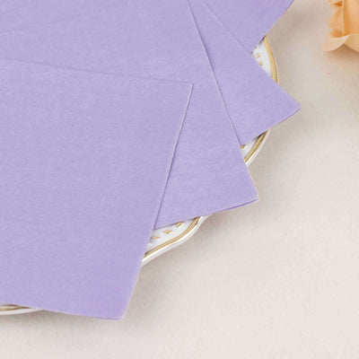 Purple cardstock sheets stacked on a decorative plate.