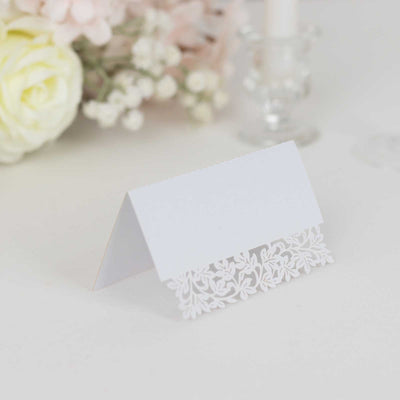 White floral place card holder on a plain background