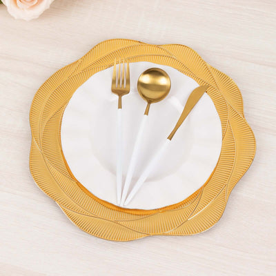 Elegant gold and white dinnerware set with a decorative plate and utensils.