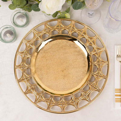 Gold decorative charger plate with intricate design on a dining table setting.