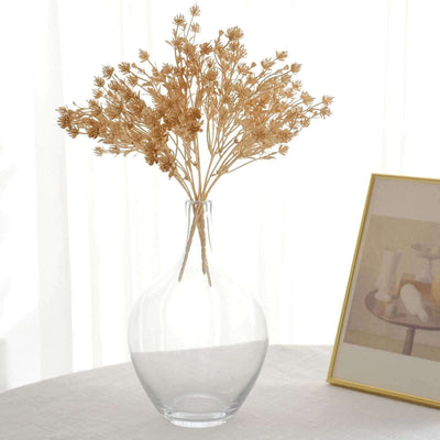Clear glass vase with dried flowers.