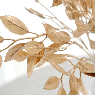Gold leaf branches with delicate details against a white background.