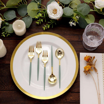 Elegant gold and teal cutlery set arranged on a white plate with floral accents.