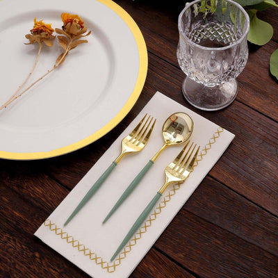 Elegant gold utensils with green handles on a napkin, styled for a dining setting.