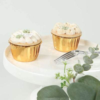 Golden cupcake gift set with decorative frosting and greenery