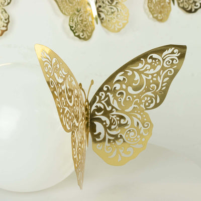 Gold decorative butterfly with intricate patterns on a white backdrop.