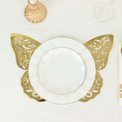 Gold butterfly-shaped placemat with white plate on elegant table setting.