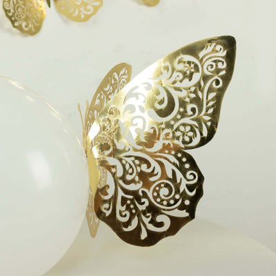 Gold ornate butterfly decoration on a white balloon.