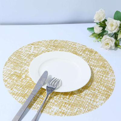 White plate with knife and fork on a gold patterned placemat