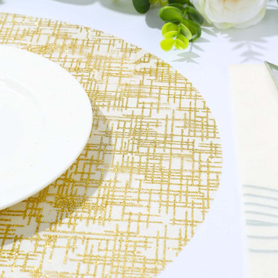 Gold patterned table runner with white plate and greenery accents.