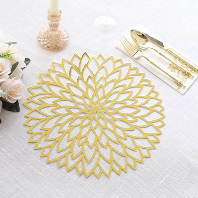 Gold floral table placemat on elegant dining setup.