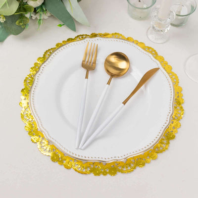 Elegant gold and white dinnerware set with decorative plate and utensils.