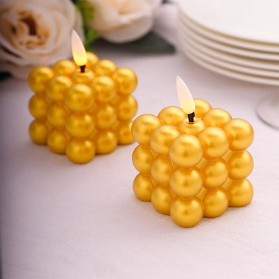 Yellow decorative bubble candles on a table setting with roses.