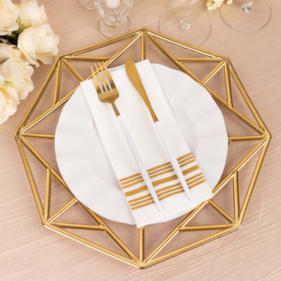 Elegant gold geometric plate charger with white plate and cutlery on a soft table setting.