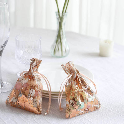 Decorative gift bags filled with colorful candies on a dining table.