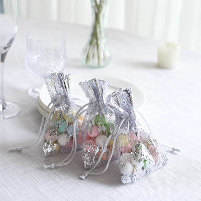 Colorful candy-filled favor bags on a table setting.