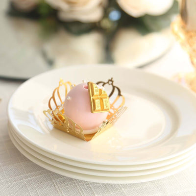 Elegant pink dessert in a gold decorative cup on a white plate.