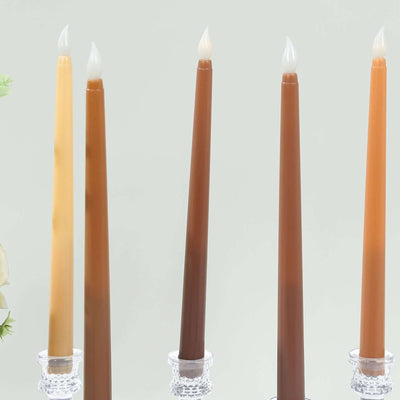 Colorful tapered candles in various shades displayed on elegant candle holders.