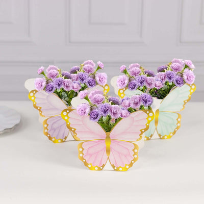 Butterfly-shaped flower pots with purple flowers for home decor.