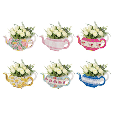 Colorful decorative teapots with floral arrangements