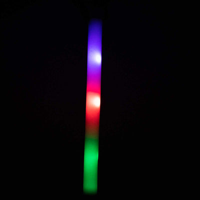 Colorful glowing LED light stick in dark background.