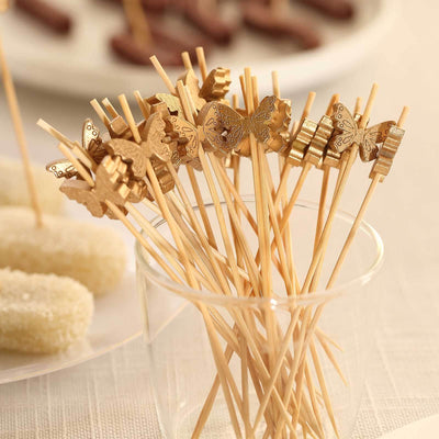 Butterfly-shaped cocktail sticks in a glass cup. Perfect for parties and events.