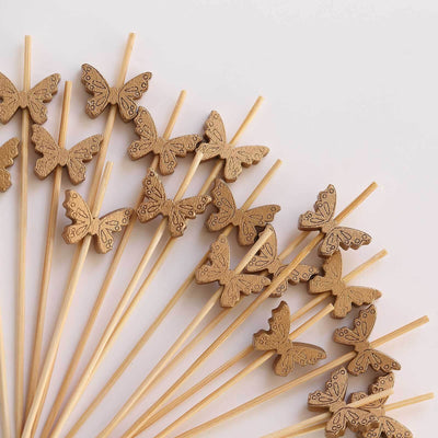 Wooden butterfly cake toppers on bamboo sticks