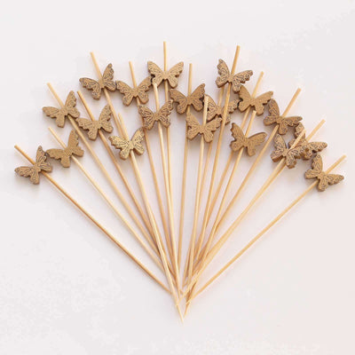 Wooden butterfly cake toppers arranged on sticks for decoration