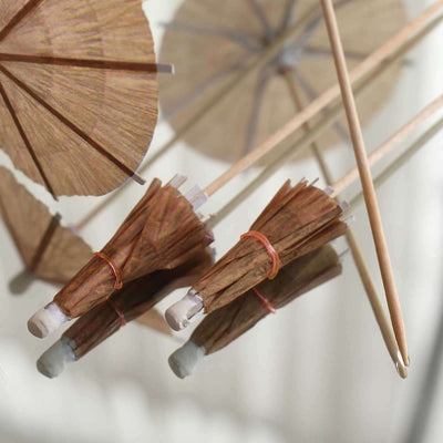 Colorful cocktail umbrellas arranged with bamboo sticks.