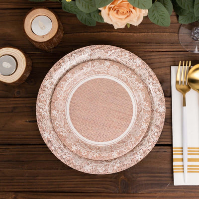 Stacked decorative plates with floral design on a wooden table setting.