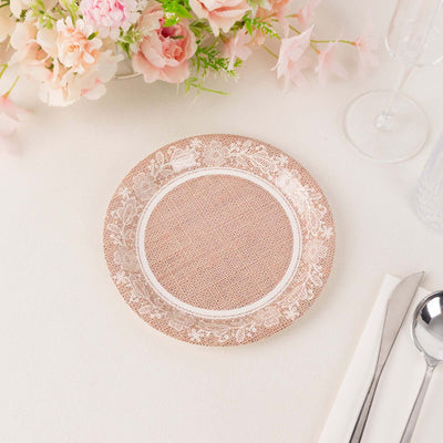 Decorative pink plate with floral design on a light table setting.