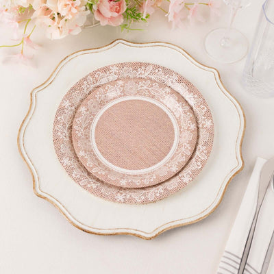 Elegant layered plates with floral lace design on a white table setting.