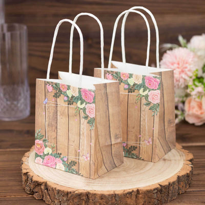 Floral gift bags on a wooden surface with flowers in the background.
