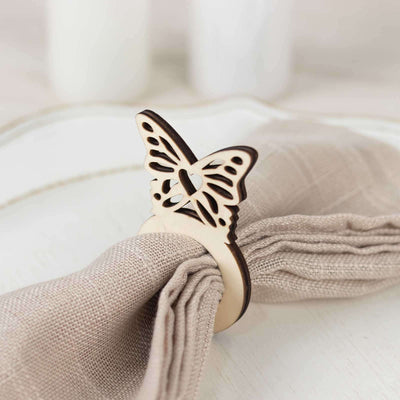 Wooden butterfly napkin ring on a linen napkin.