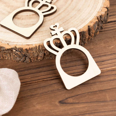 Wooden crown-shaped cutout on rustic wood slice.