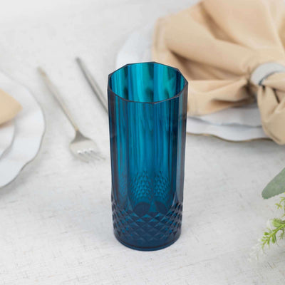 Blue geometric glass vase on a table setting.